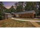 Beautiful exterior elevation with stone and manicured lawn at 9025 Huntcliff Trce, Atlanta, GA 30350