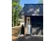 Garage exterior featuring stone and painted siding at 9025 Huntcliff Trce, Atlanta, GA 30350