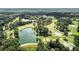 Aerial view of golf course with a large pond and lush green fairways at 9025 Huntcliff Trce, Atlanta, GA 30350