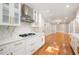 Updated kitchen with white cabinets and quartz countertops at 9025 Huntcliff Trce, Atlanta, GA 30350