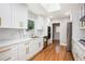 Bright kitchen featuring white cabinets, quartz countertops and stainless steel appliances at 9025 Huntcliff Trce, Atlanta, GA 30350