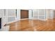 Spacious living room featuring hardwood floors, white trim, and large windows for natural light at 9025 Huntcliff Trce, Atlanta, GA 30350