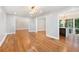 Open concept living room with hardwood floors and modern light fixture at 9025 Huntcliff Trce, Atlanta, GA 30350