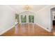 Living room featuring large windows and hardwood floors at 9025 Huntcliff Trce, Atlanta, GA 30350
