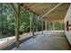 Covered patio with view of lush greenery and pool offers serene outdoor living space at 9025 Huntcliff Trce, Atlanta, GA 30350