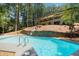 Gorgeous inground pool, cascading waterfall and wooded views at 9025 Huntcliff Trce, Atlanta, GA 30350