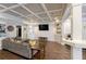 Finished basement with seating area, white trim, coffered ceilings, and built-in display shelving at 998 Poplar Mill Ct, Buford, GA 30518