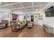 Finished basement with a large seating area, desk, coffered ceiling and hardwood-style floors at 998 Poplar Mill Ct, Buford, GA 30518