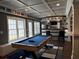 Finished basement featuring a pool table, coffered ceiling, ample room for activities and bar area at 998 Poplar Mill Ct, Buford, GA 30518