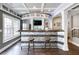 Finished basement with a stylish bar featuring a marble countertop and seating for entertainment at 998 Poplar Mill Ct, Buford, GA 30518