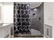 Updated bathroom with a black and white shower curtain and a tile shower with a built in shelf at 998 Poplar Mill Ct, Buford, GA 30518
