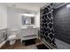 Updated bathroom with a black and white shower curtain, gray tile shower, and a white vanity with a vessel sink at 998 Poplar Mill Ct, Buford, GA 30518