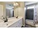 Bright bathroom features double sinks, quartz countertops, and bathtub with shower at 998 Poplar Mill Ct, Buford, GA 30518
