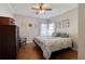 Comfortable bedroom with a ceiling fan and natural light streaming through the curtained windows at 998 Poplar Mill Ct, Buford, GA 30518