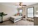 Cozy bedroom features natural light, neutral tones, and a ceiling fan at 998 Poplar Mill Ct, Buford, GA 30518