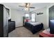 This bedroom features neutral tones, a ceiling fan, and decor at 998 Poplar Mill Ct, Buford, GA 30518