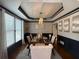 Elegant dining room with modern chandelier, decorative molding, and large windows for natural light at 998 Poplar Mill Ct, Buford, GA 30518