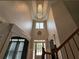 Grand two story foyer highlighting a chandelier, front door, and natural light at 998 Poplar Mill Ct, Buford, GA 30518