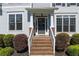 Close up of front porch and front door featuring brick steps, white railings and decorative details at 998 Poplar Mill Ct, Buford, GA 30518