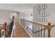 Hallway featuring hardwood floors, decorative chandelier and a personalized crossword wall decor at 998 Poplar Mill Ct, Buford, GA 30518