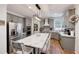 Well-lit gray kitchen featuring a center island with marble top, stainless steel appliances, and ample cabinet space at 998 Poplar Mill Ct, Buford, GA 30518