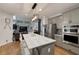 Bright kitchen flows into the living room, featuring stainless steel appliances and a spacious marble-top center island at 998 Poplar Mill Ct, Buford, GA 30518