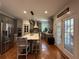 Eat-in kitchen features stainless steel appliances, gray cabinets, and hardwood floors at 998 Poplar Mill Ct, Buford, GA 30518