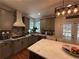 Spacious kitchen features stainless steel appliances, a white marble island, and a range hood for gourmet cooking at 998 Poplar Mill Ct, Buford, GA 30518