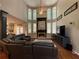 Elegant living room has high ceilings, lots of natural light, and cozy fireplace at 998 Poplar Mill Ct, Buford, GA 30518