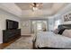 Bright main bedroom features tray ceilings, hardwood floors and open layout at 998 Poplar Mill Ct, Buford, GA 30518
