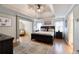 Spacious main bedroom with tray ceilings, hardwood floors, sitting area and ensuite bath at 998 Poplar Mill Ct, Buford, GA 30518