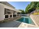 Inviting backyard swimming pool with a patio, lounge chairs, and an outdoor living space for relaxation at 998 Poplar Mill Ct, Buford, GA 30518