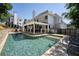 Backyard swimming pool surrounded by landscaped greenery and outdoor living space, perfect for entertaining guests at 998 Poplar Mill Ct, Buford, GA 30518