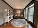 Sitting area showcasing hardwood floors, decorative accents, and natural light from large windows at 998 Poplar Mill Ct, Buford, GA 30518