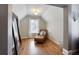 Cozy sitting area with hardwood floors, accent chair, and natural light at 998 Poplar Mill Ct, Buford, GA 30518