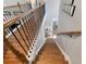 Staircase with wood steps and ornate metal railings showcasing home's multi-level design at 998 Poplar Mill Ct, Buford, GA 30518