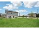 Expansive backyard with lush green grass and houses in the distance offers a peaceful outdoor space at 1001 Starmoss Ln, Conyers, GA 30094