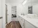 Bathroom featuring double vanity, wood-look floor, shower, and doorway to bedroom at 1001 Starmoss Ln, Conyers, GA 30094