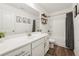 Bright bathroom features white cabinets, a large mirror, and a shower-tub combination at 1001 Starmoss Ln, Conyers, GA 30094