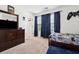 A bedroom with a dark wood dresser, gaming decorations, and carpet flooring for cozy comfort at 1001 Starmoss Ln, Conyers, GA 30094