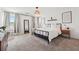 Bright bedroom boasts neutral walls, carpeted flooring, and large windows for ample natural light at 1001 Starmoss Ln, Conyers, GA 30094