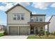 Charming two-story home with a two-car garage and landscaped front yard at 1001 Starmoss Ln, Conyers, GA 30094