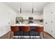 Modern kitchen boasts white cabinets, stainless appliances, and a large island with seating at 1001 Starmoss Ln, Conyers, GA 30094