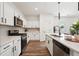 Stylish kitchen with white cabinets, stainless steel appliances, and quartz countertops at 1001 Starmoss Ln, Conyers, GA 30094