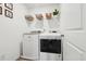 Laundry room features a washer, dryer, and shelving for storage and organization at 1001 Starmoss Ln, Conyers, GA 30094