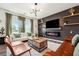 Beautiful living room with dark accent wall, fireplace, and modern decor at 1001 Starmoss Ln, Conyers, GA 30094