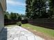 Cozy backyard featuring a stone patio, well-maintained lawn, and a dark wood fence, perfect for outdoor relaxation at 2871 Goldfinch Cir, Marietta, GA 30066
