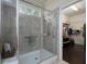 Modern tiled shower with glass doors and chrome fixtures adjacent to walk-in closet at 2871 Goldfinch Cir, Marietta, GA 30066
