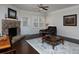 Cozy living room featuring a stone fireplace, a ceiling fan, hardwood floors and great lighting at 2871 Goldfinch Cir, Marietta, GA 30066