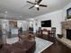 Open concept living room with stone fireplace, hardwood floors and view of kitchen at 2871 Goldfinch Cir, Marietta, GA 30066